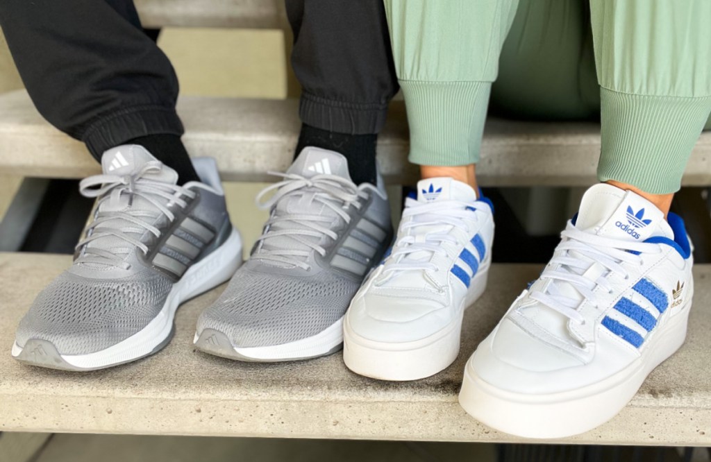 two pairs of adidas shoes on stairs