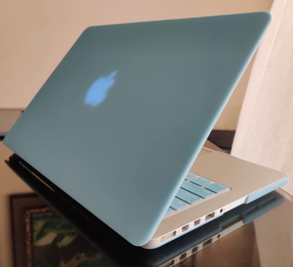 close up of blue apple mac laptop with blue cover on back