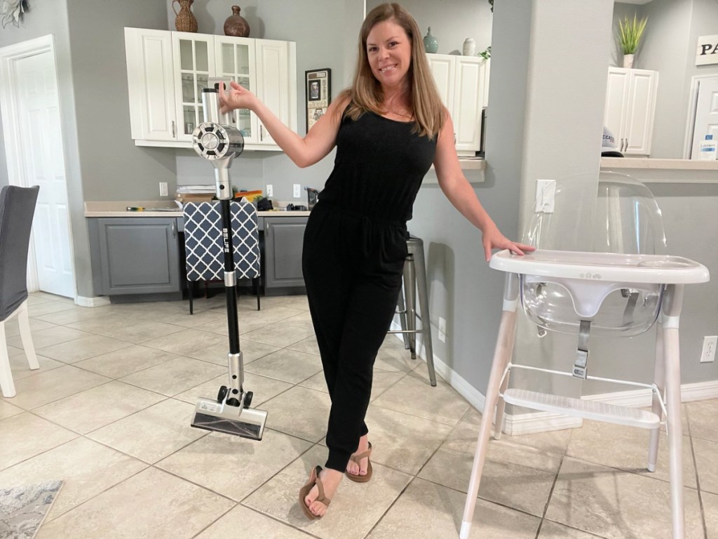 woman holding up a belife s10 cordless vacuum