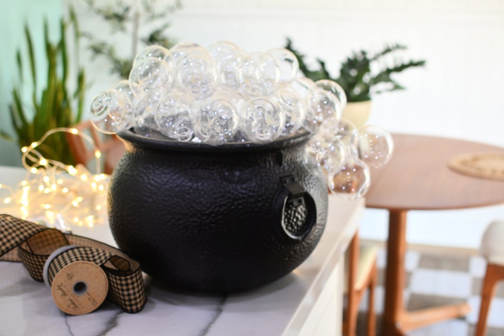 black plastic cauldron with clear ornaments