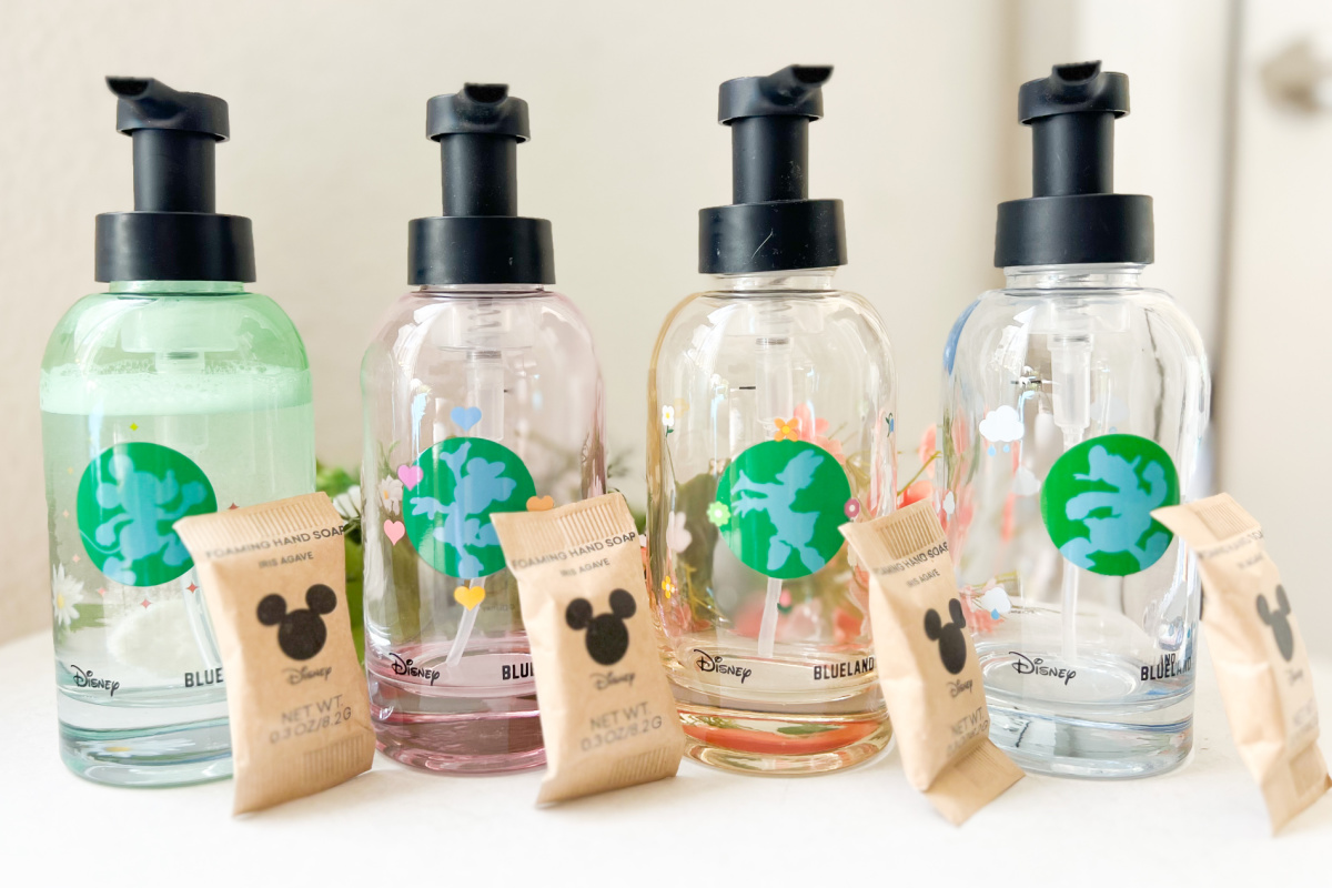 four glass disney soap bottles with soap tablets