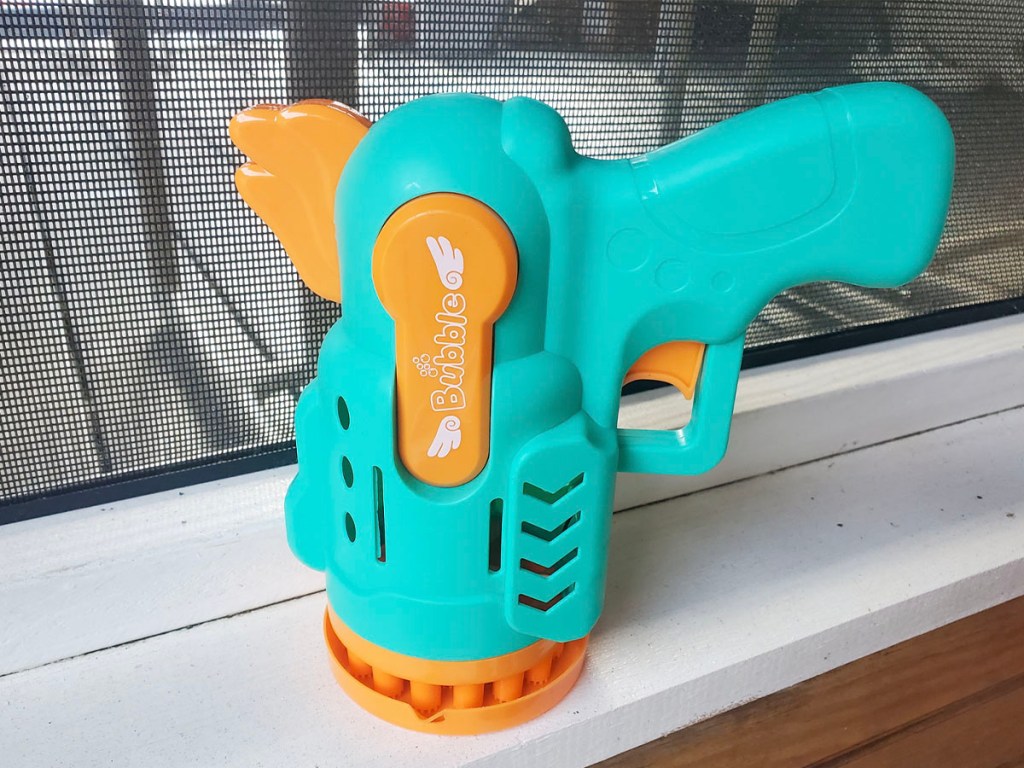 teal and orange bubble blower sitting on table