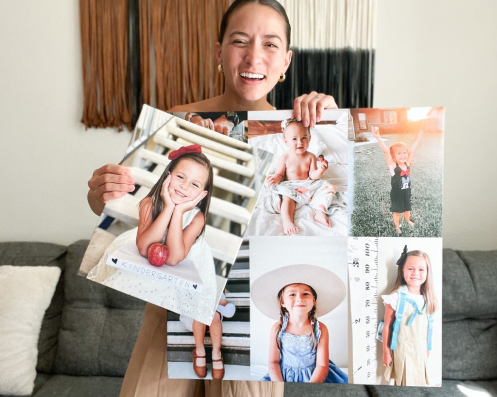 woman holding two photo canvases