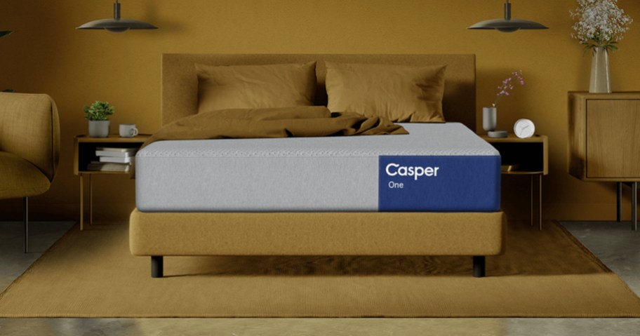 casper one mattress on bed with yellow blanket and pillow