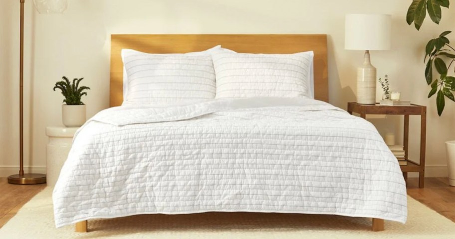 white quilt on bed with pillows