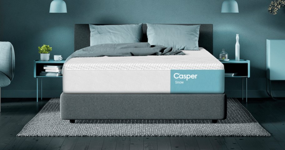 casper snow mattress with teal blanket and pillows on bed