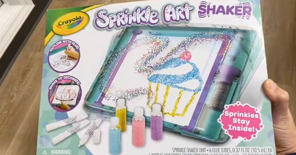 hand holding crayola sprinkle art kit box