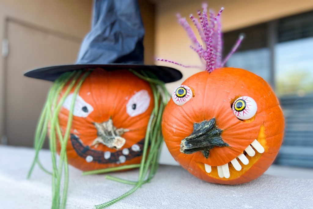 two pumpkins with stem as nose