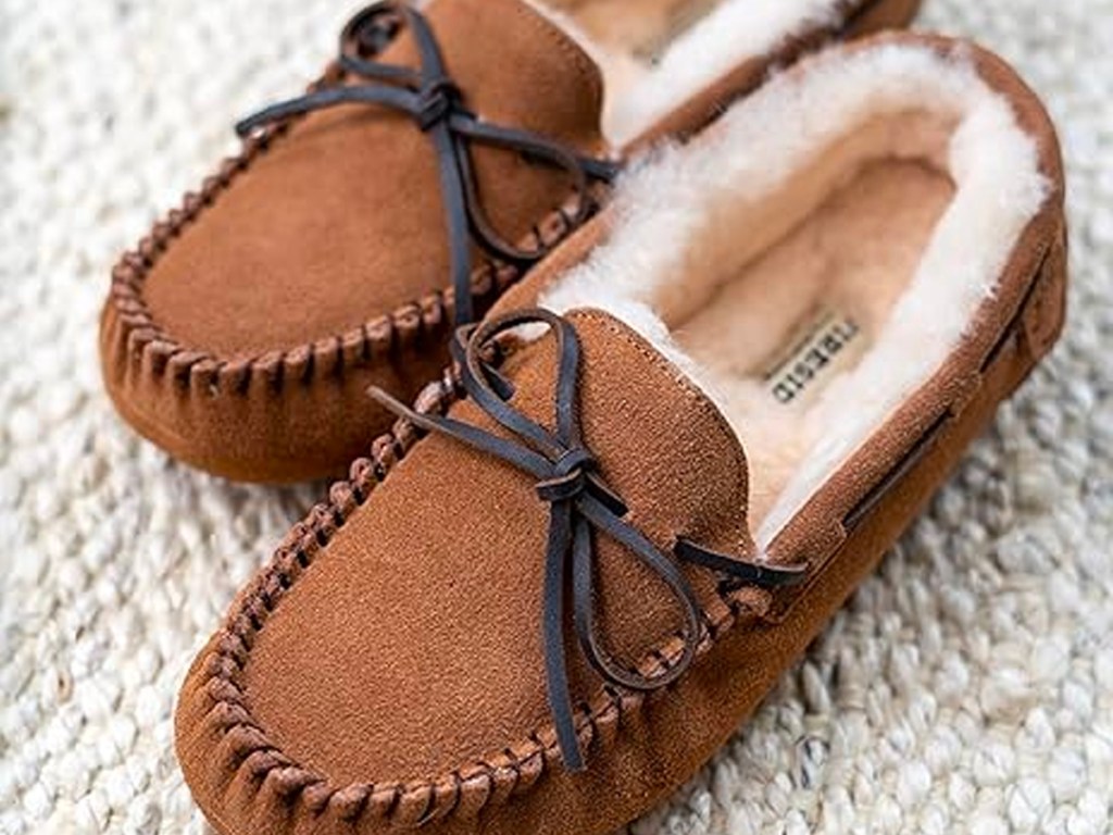 brown dearfoam slippers on gray carpet