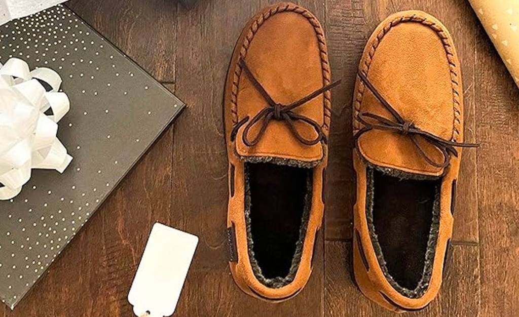 tan mocassin slippers next to gift box and tag