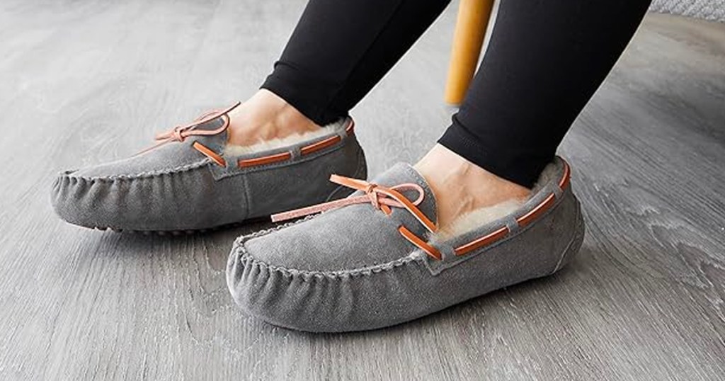 woman wearing gray dearfoam slippers on gray tile