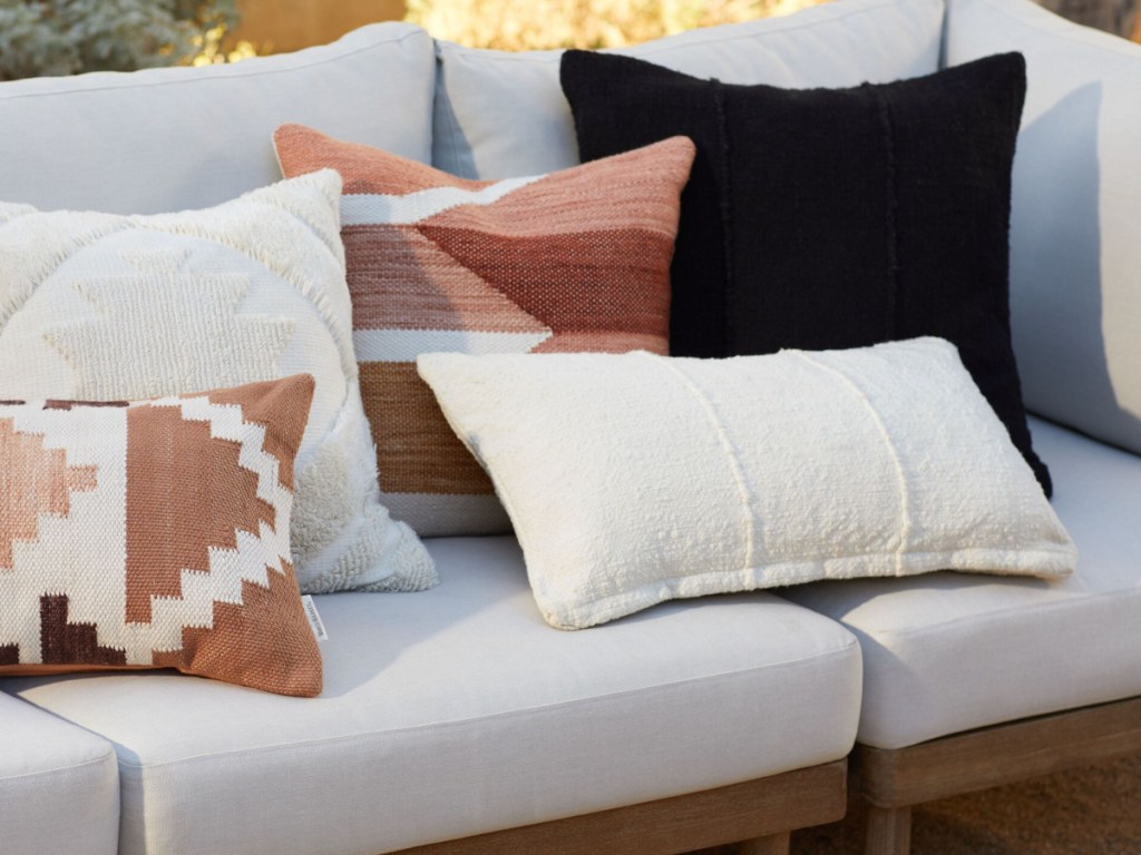 display of throw pillows on couch outdoors