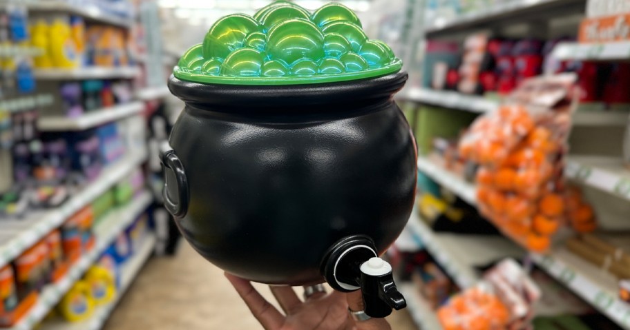 hand holding bubbling cauldron drink dispenser
