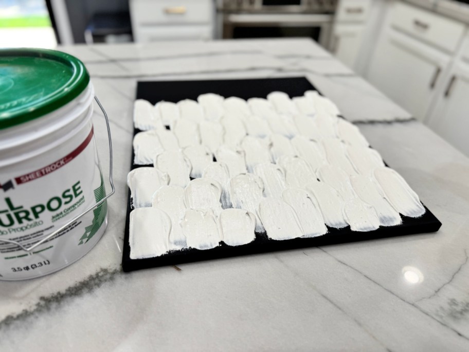 drywall compound ghost on a black canvas