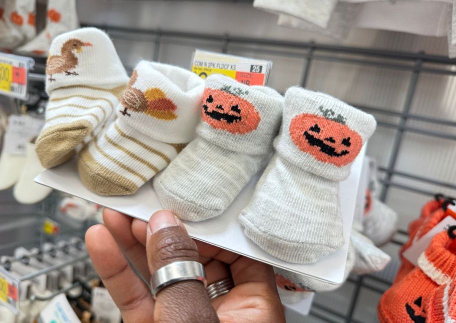 two pair of babys booties with turkeys and jack o lanterns on them