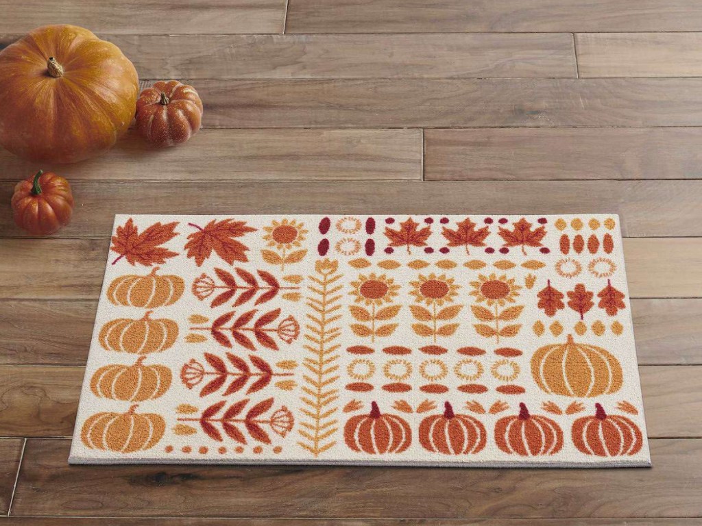 fall rug displayed with pumpkins on the side