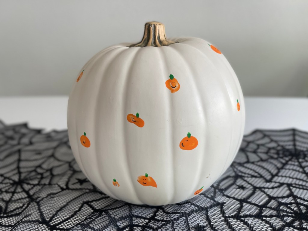 faux pumpkin with fingerprint pumpkins on it