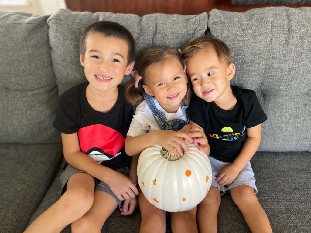 kids holding faux pumpkin