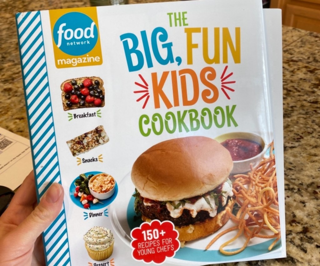 holding a kids' cookbook