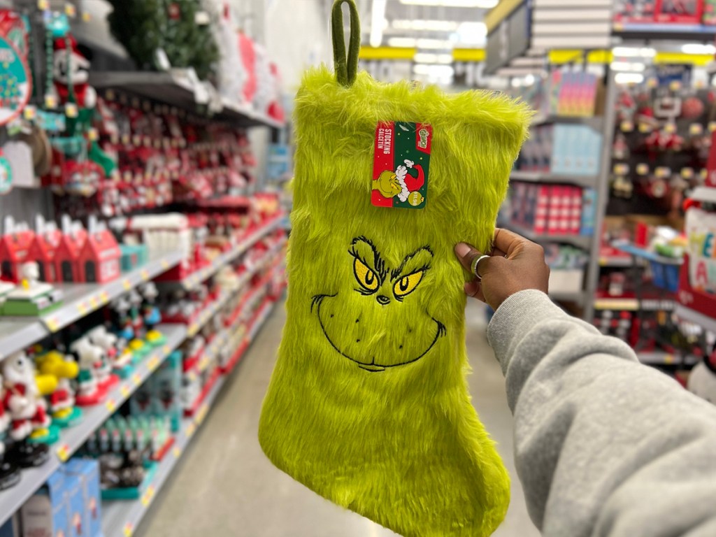 hand holding grinch stocking