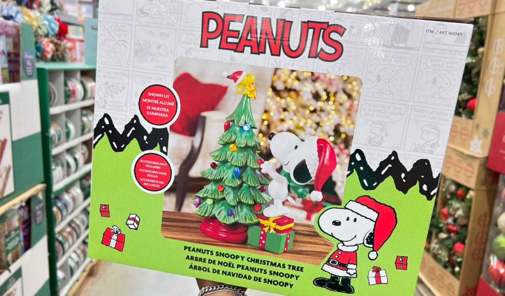 hand holding Peanuts Snoopy LED Holiday Tree at costco store