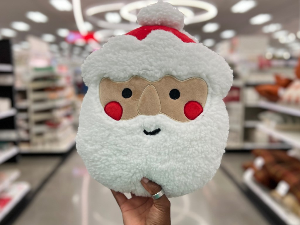 hand holding Santa head pillow