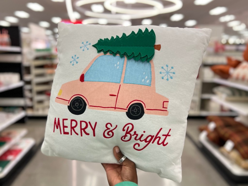 hand holding Wondershop Merry and Bright Car Embroidered Christmas Square Throw Pillow