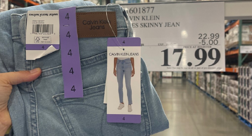 hand holding calvin Klein jeans at Costco store