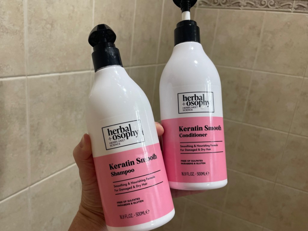 hand holding keratin shampoo and conditioner in the shower