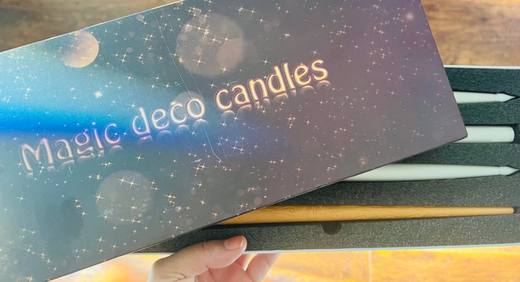 hand holding magic deco candles with the box open