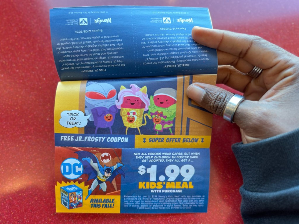 hand holding wendys boo book open with offers showing