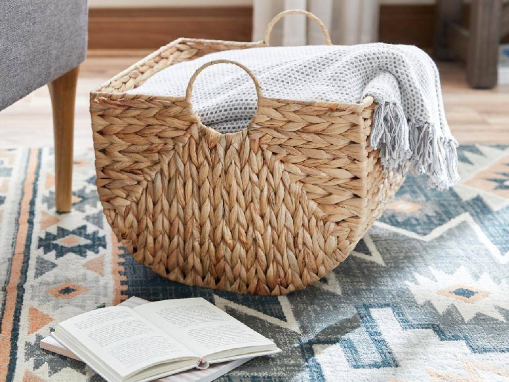 home depot basket with blanket displayed in the living room with books