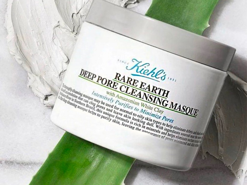 jar of Kiehl's Rare Earth Deep Pore Cleansing Masque with some on the side and aloe leaf behind 