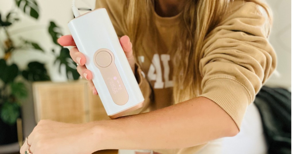 Woman using Laser Hair remover on arms