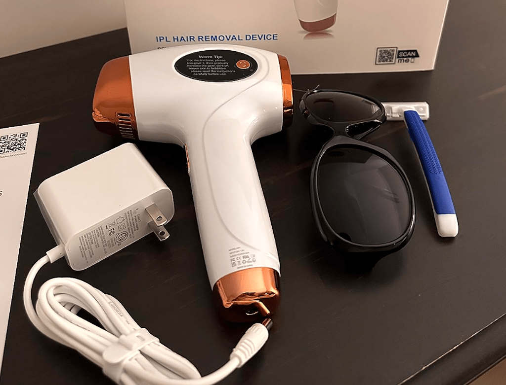 laser hair removal device and accessories on table