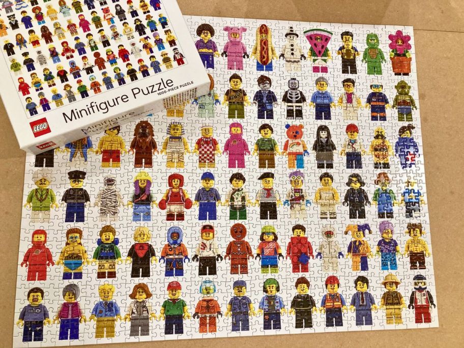 lego minifigure puzzle assembled on a table shown with box