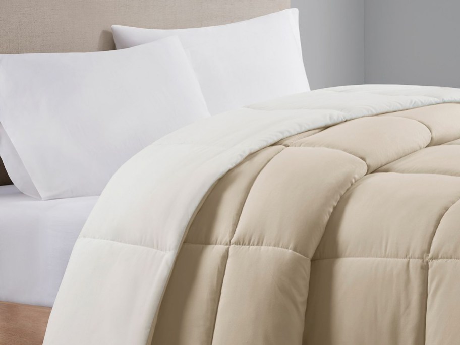 reversible tan and white comforter on bed