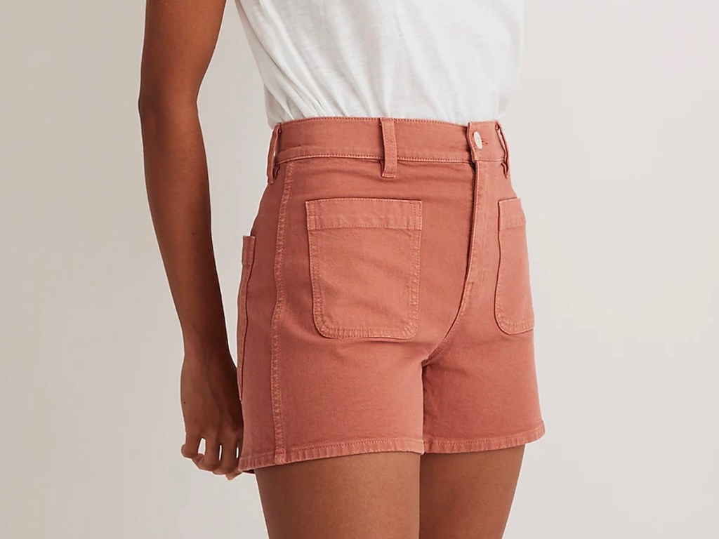 woman wearing pink shorts and white tee