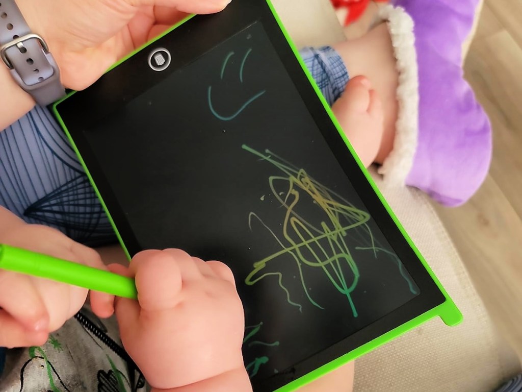 baby scribbling on a magic doodle board
