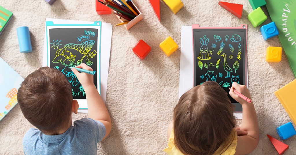 kids laying on the floor drawing on magic doodle boards