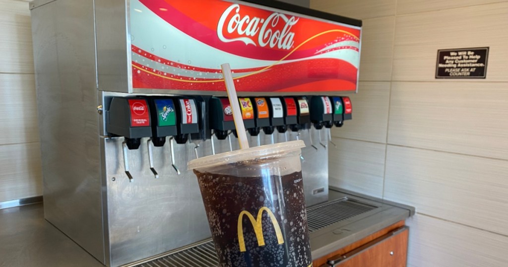 holding fountain soda at McDonald's self-serve drink station