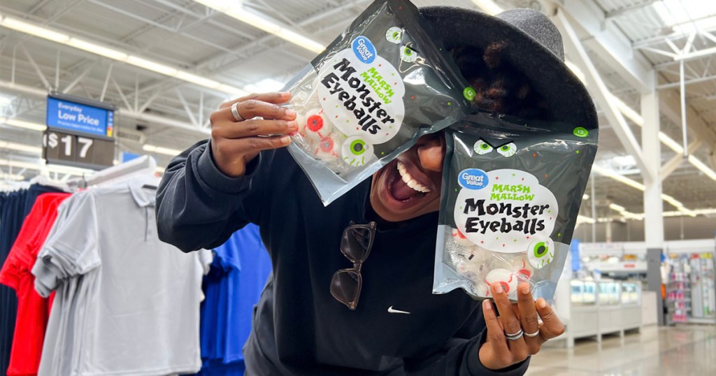 woman holding two bags of monster eyeball marshmallows