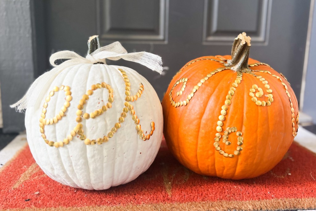 two pumpkins with gold thumbtack designs