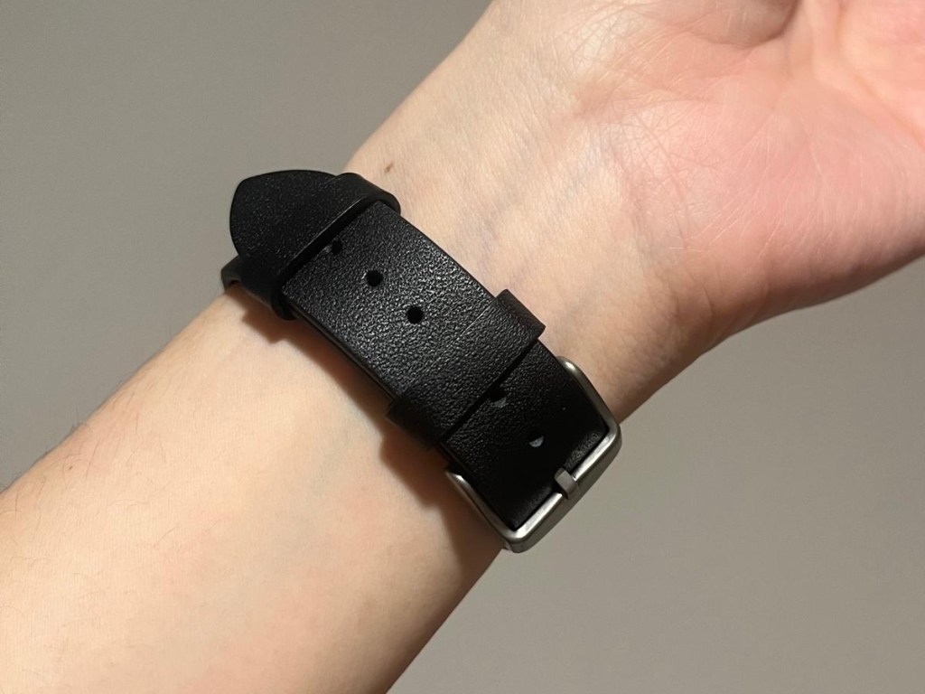 woman's wrist with black Apple Watch band