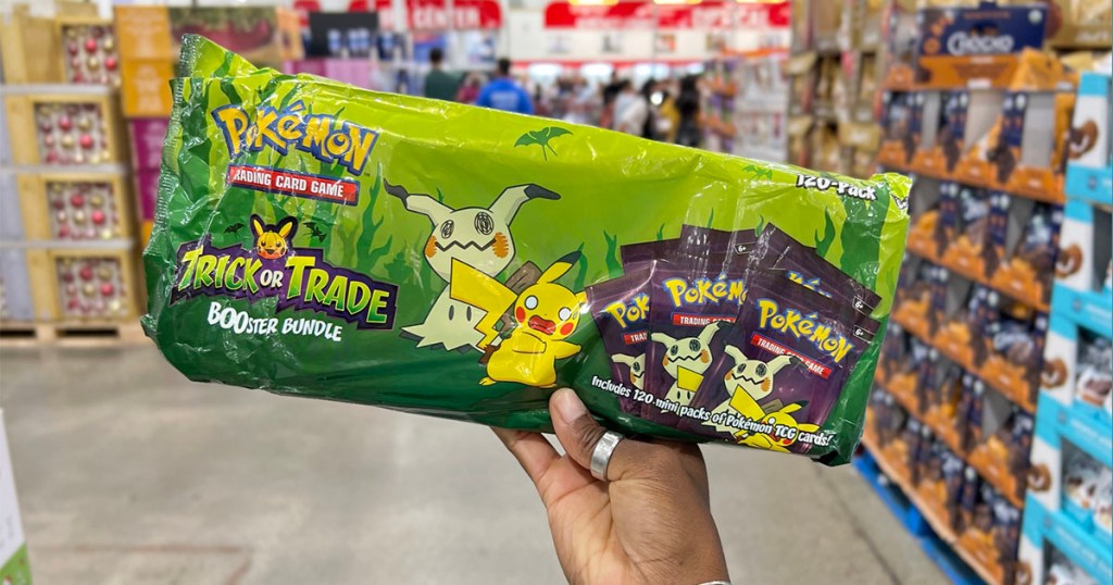 hand holding pokemon booster pack