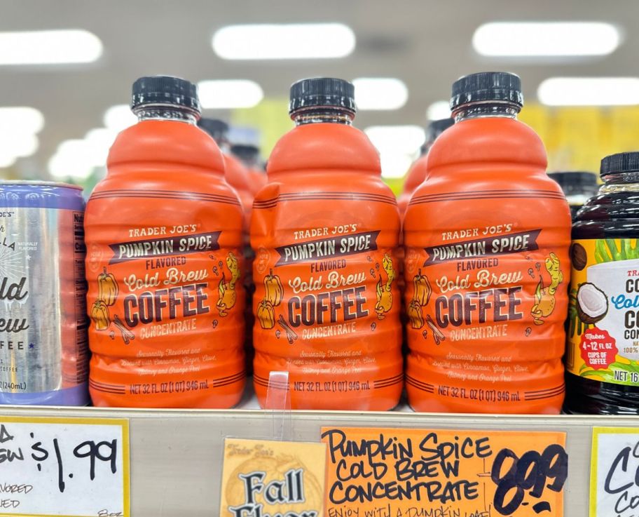 a womans hand holding a jug of pumpkin spiced cold brew