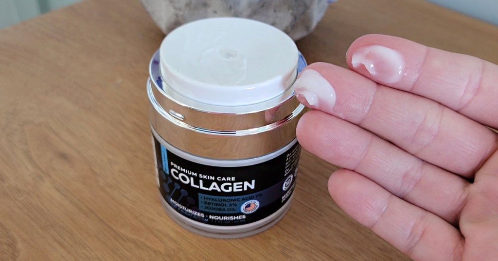 raw science collagen open jar next to hand with with product on fingers