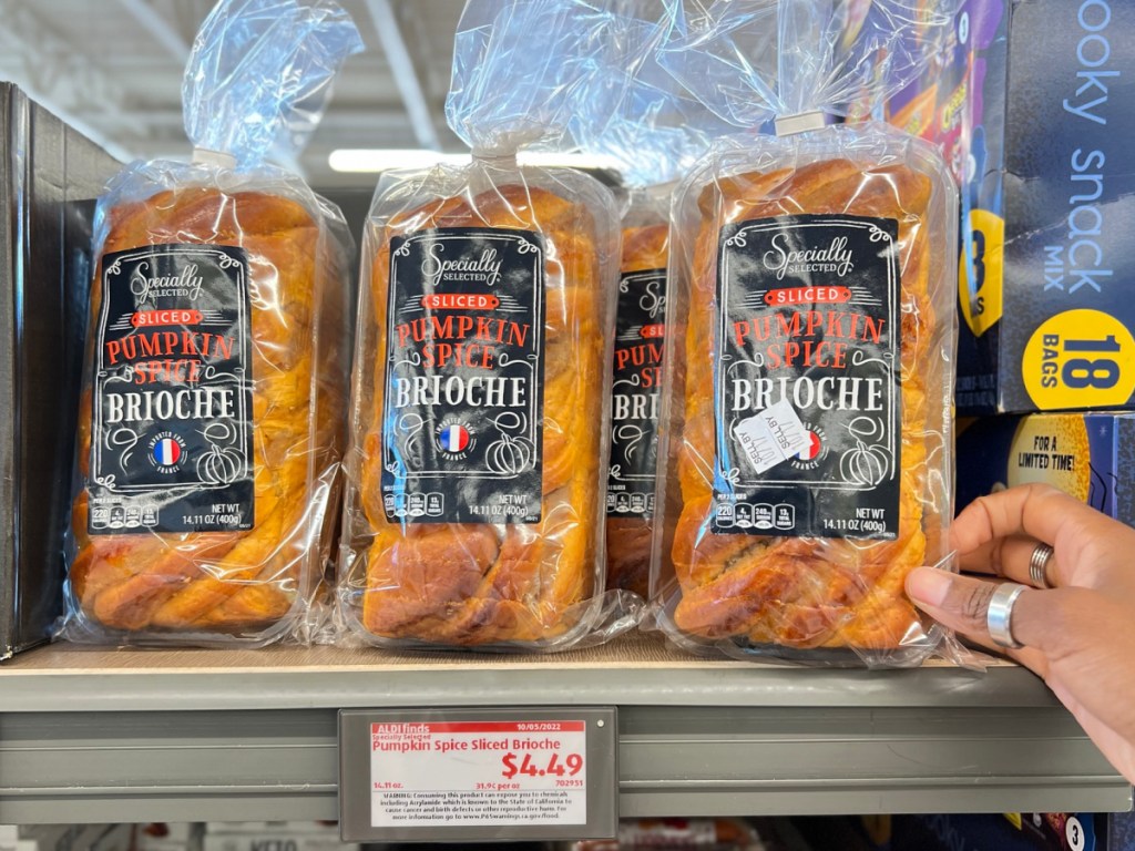 row of 3 Specially Selected Pumpkin Spice Sliced Brioche with hand holding it
