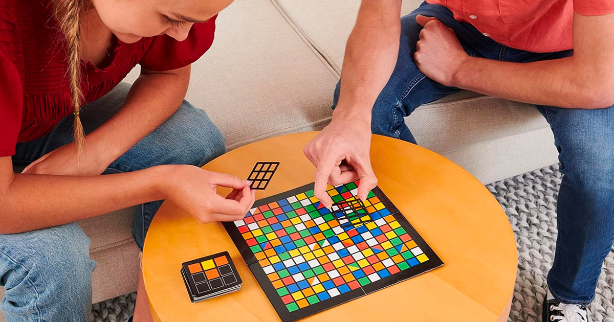 two people playing with rubiks board game