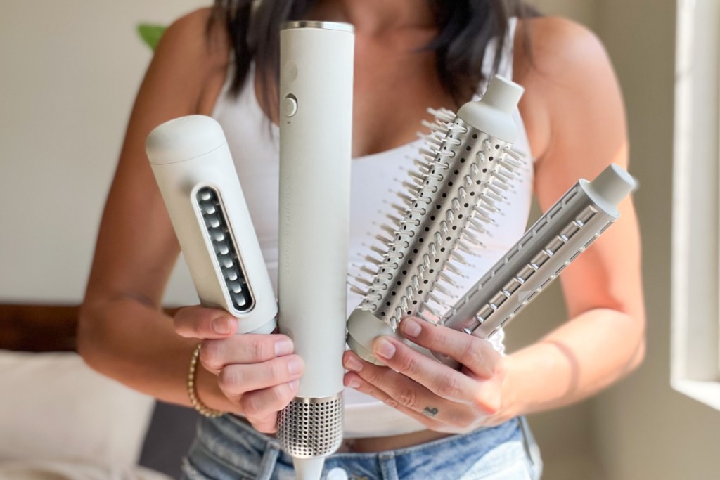 woman holding hair styler and attachments